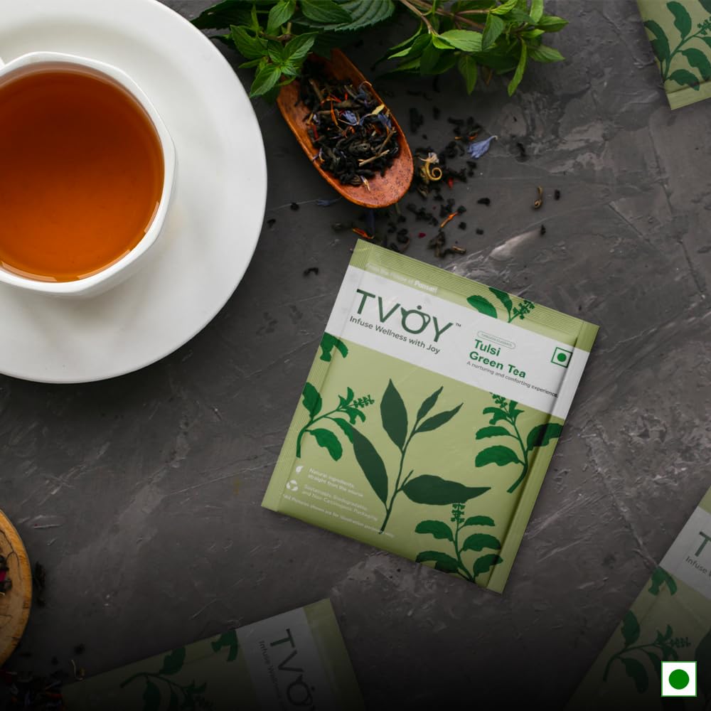 TVOY Tulsi Green Tea with a cup of freshly brewed tulsi-infused green tea.
